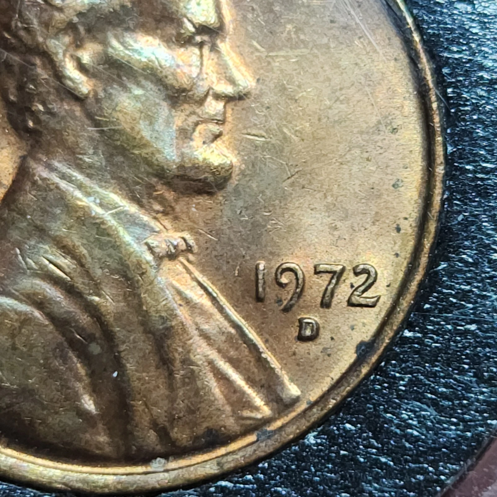 Close-up of 1972-D penny repunched mint mark showing secondary D impression offset from primary mint mark